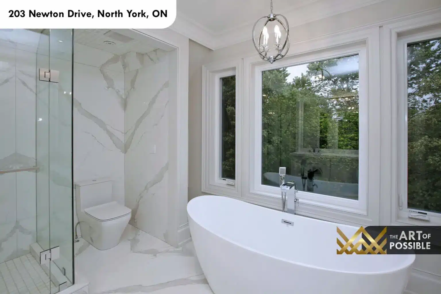 Frameless glass shower with rain head and body jets in book-matched marble