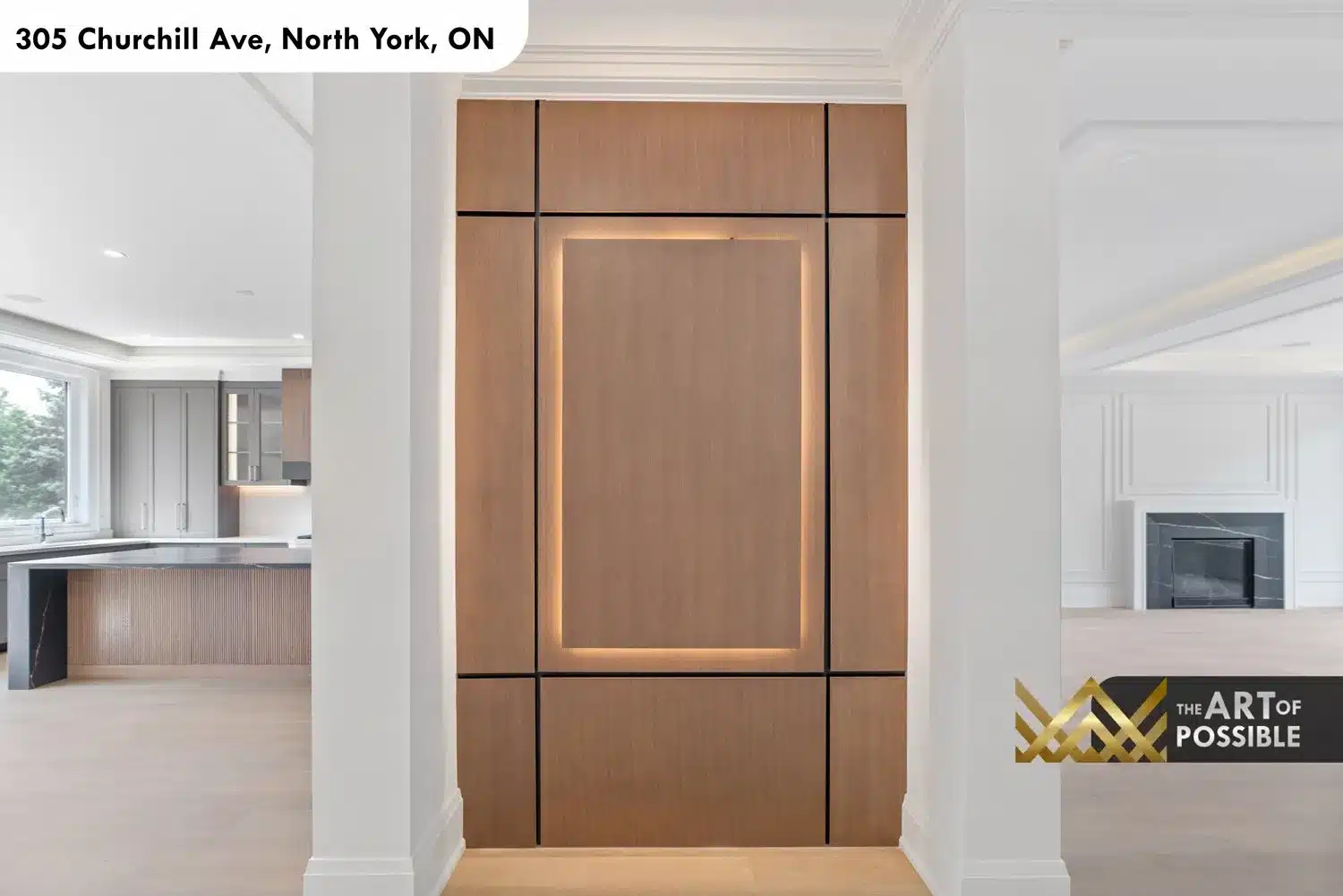 Walnut panel room divider with black shadow-gap grid and LED backlit center panel between kitchen and family room