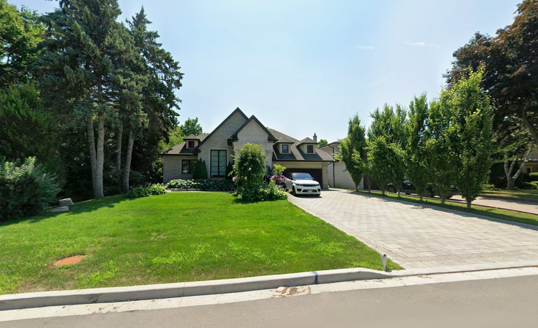 161 Royal Orchard Blvd, Thornhill: A Multi-Gable Custom Home with Stone Cladding, Dormer Details and an Interlock Paver Driveway