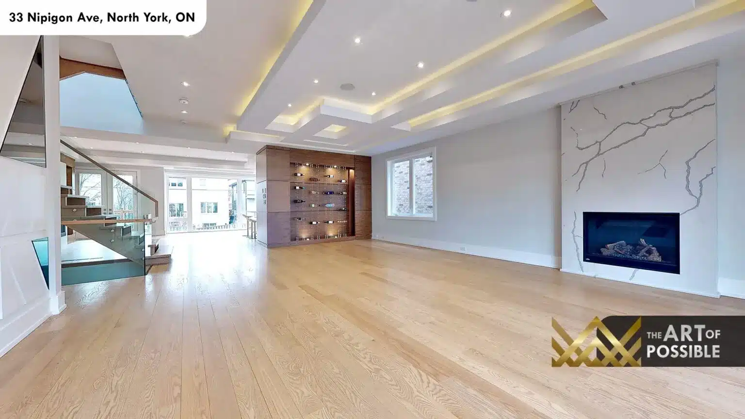 33 Nipigon Ave living room with marble fireplace surround, wine wall and coffered tray ceilings