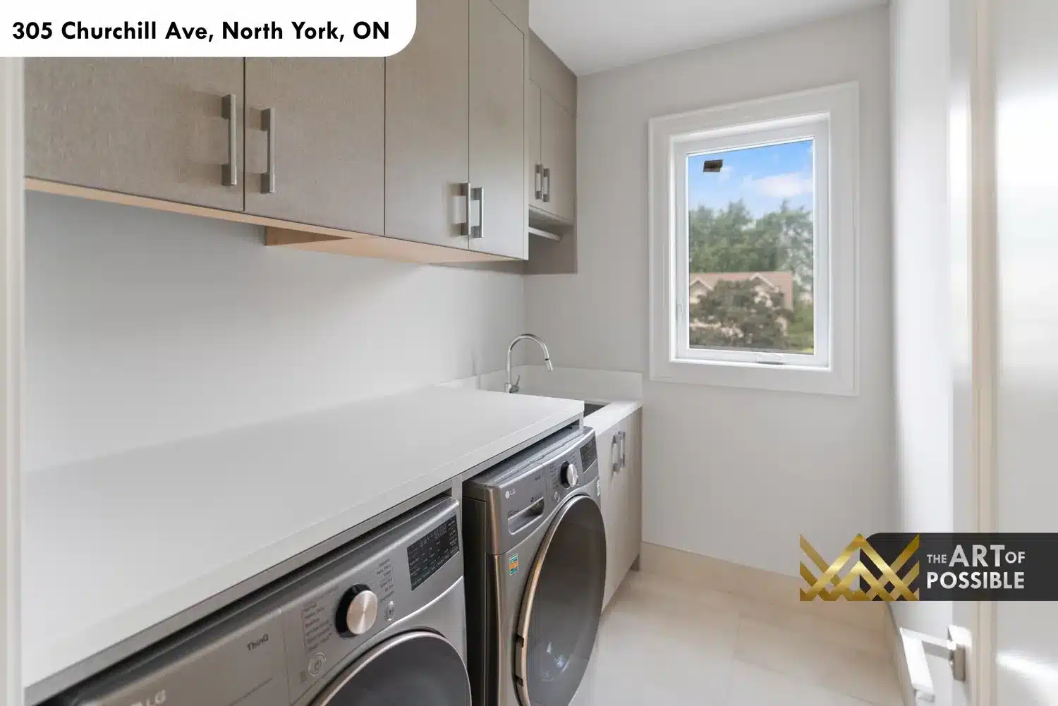 Second floor laundry room with LG washer and dryer, white quartz folding counter and greige upper cabinets