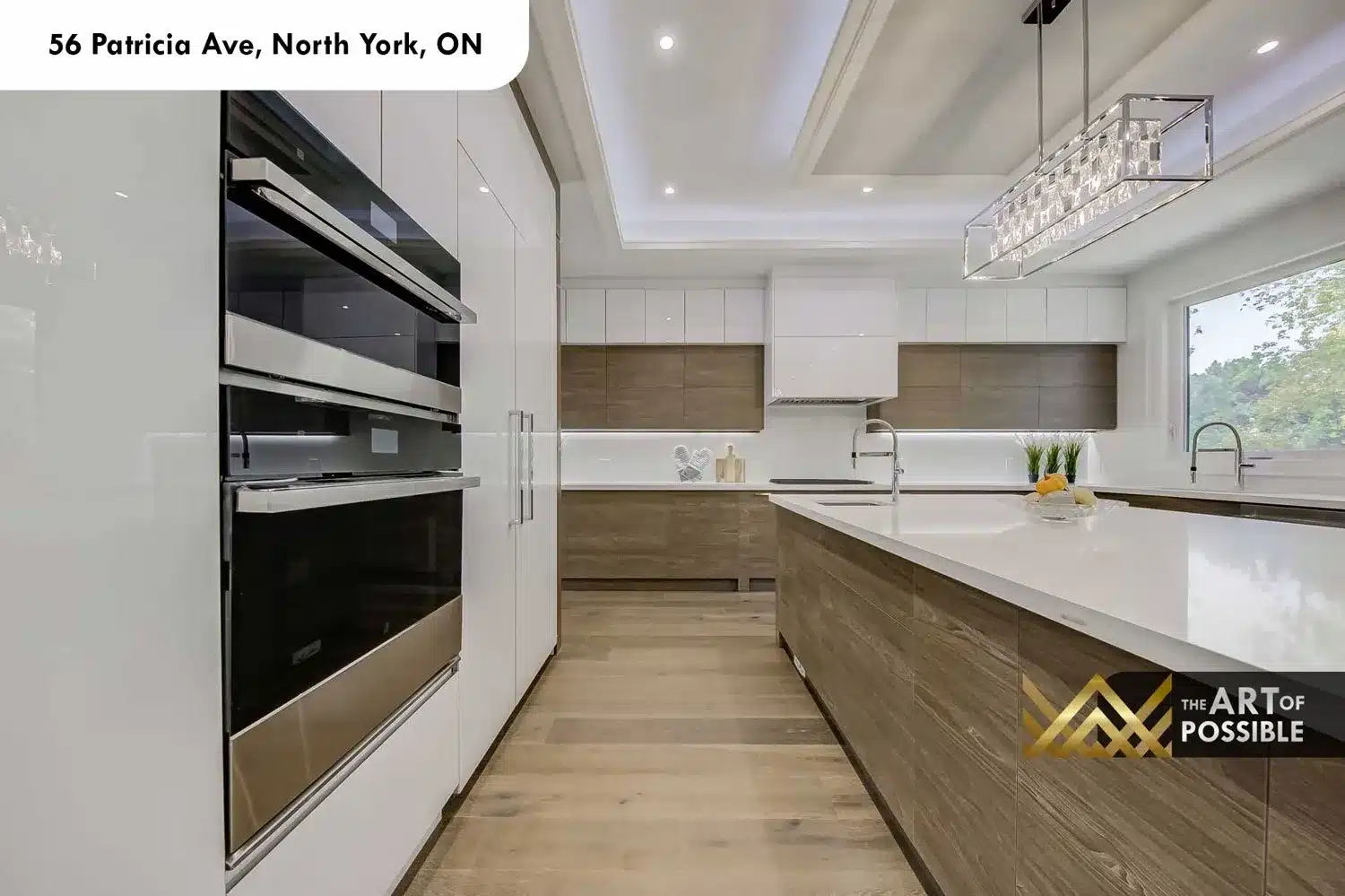Kitchen perimeter counters with wall ovens and wood veneer cabinetry at 56 Patricia Ave