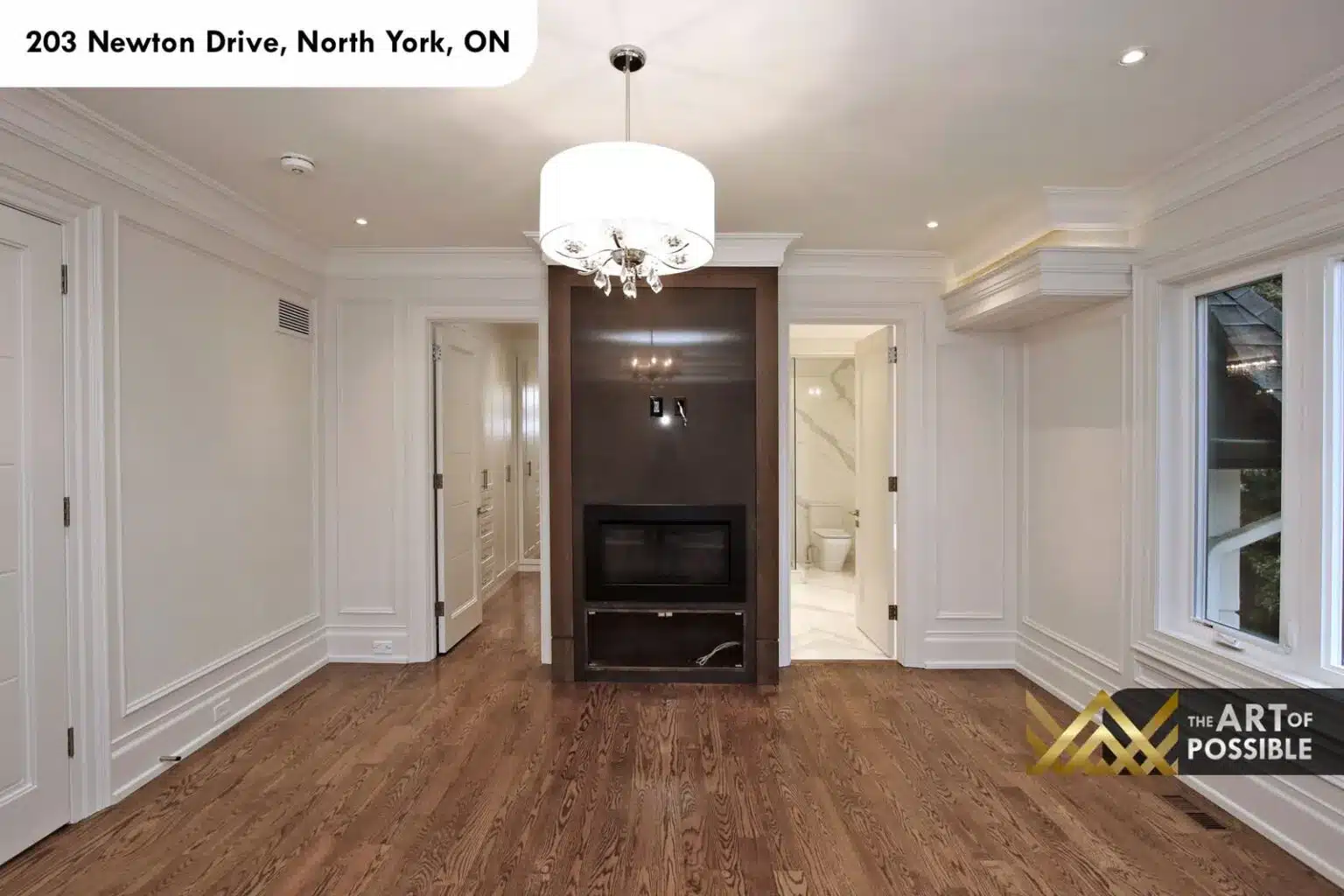 Bedroom with drum chandelier, fireplace niche and ensuite access