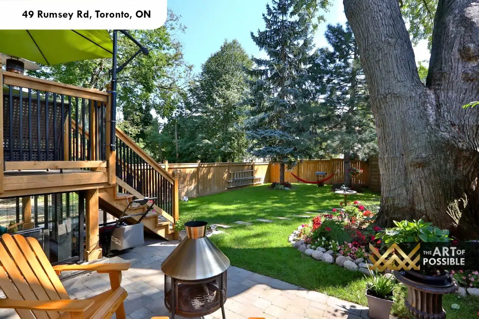 49 Rumsey Rd rear yard wood deck iron railings stone patio mature trees