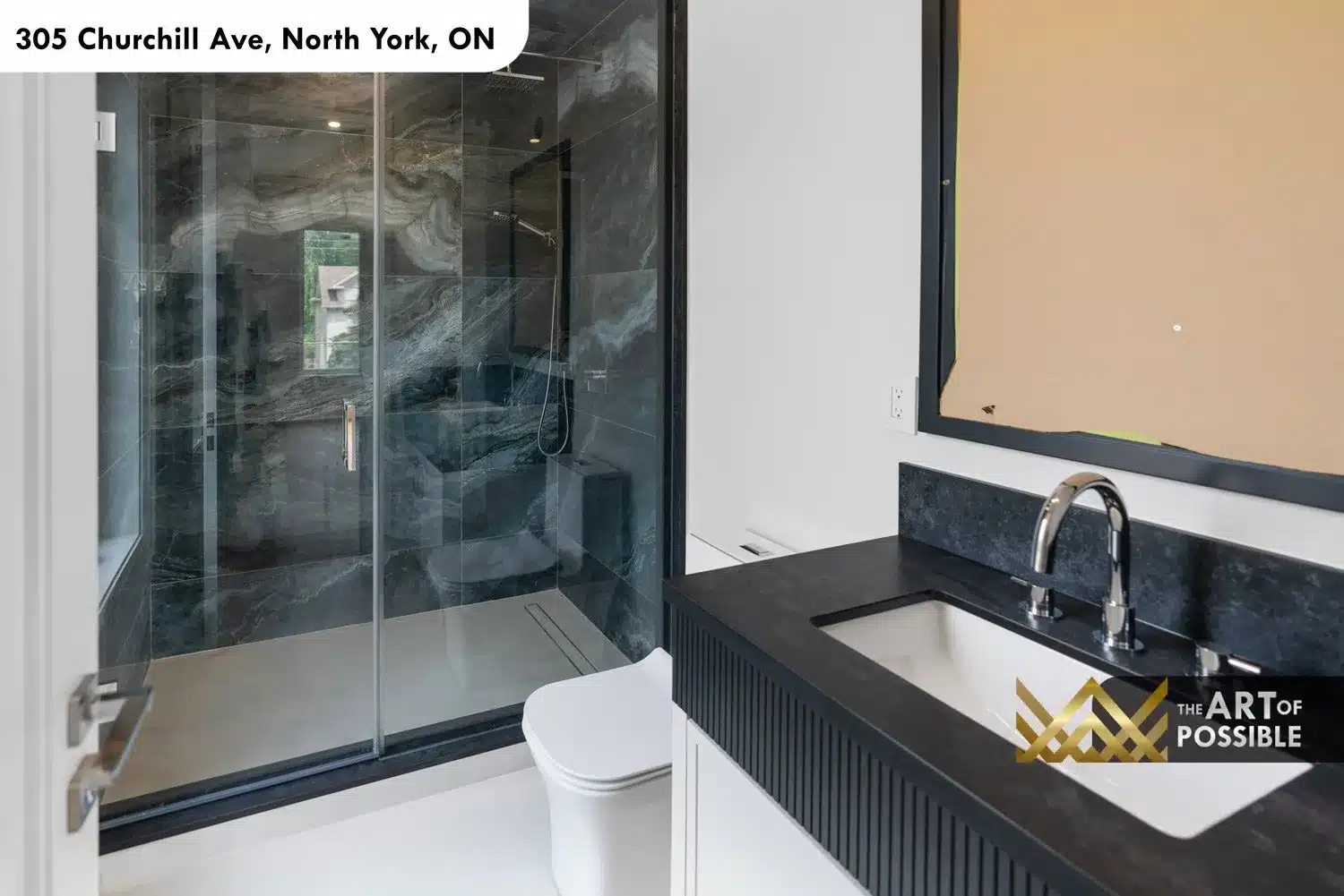 Secondary bathroom with reeded charcoal vanity, black quartz countertop and dark swirling marble shower
