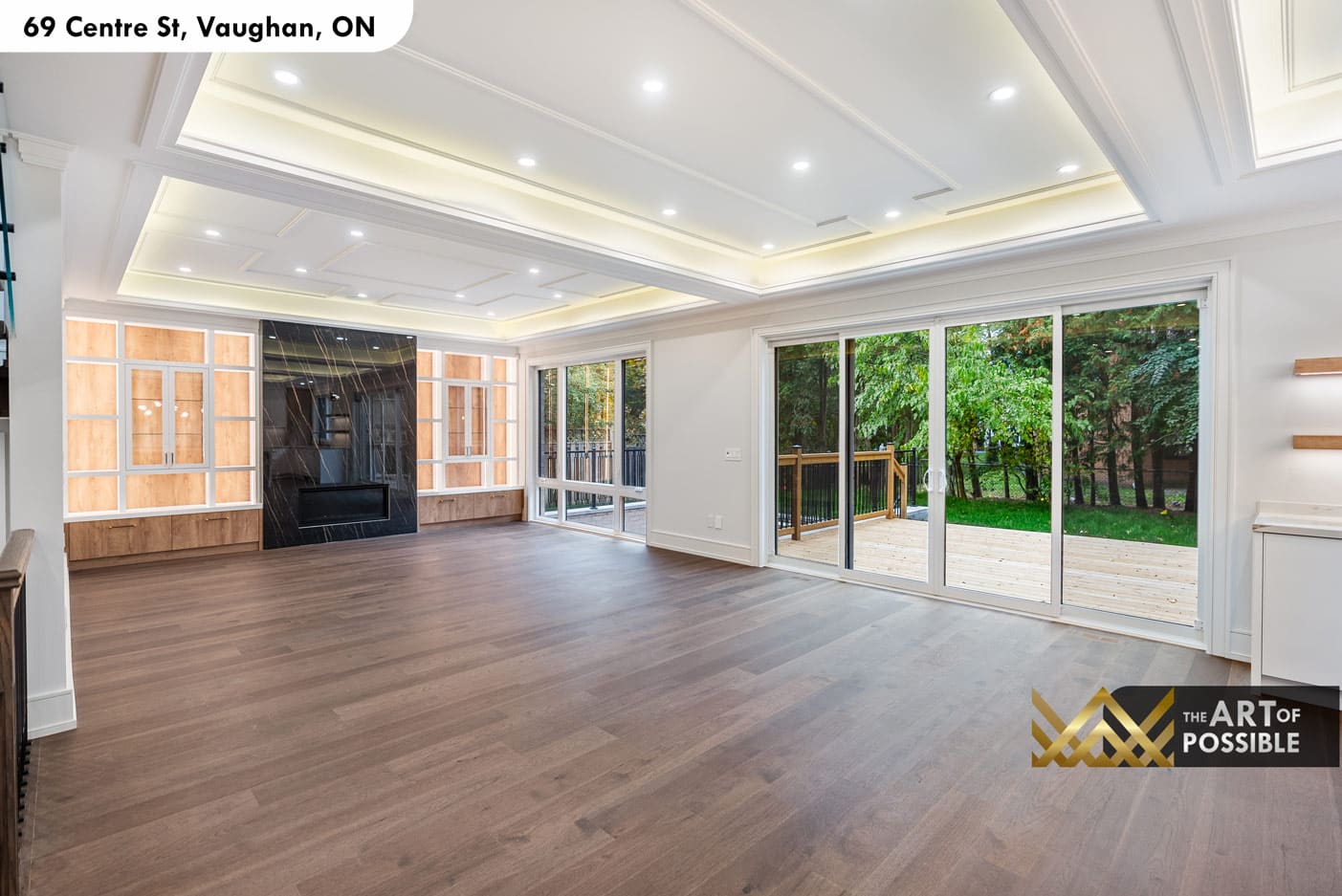 Family room rear view showing sliding doors to deck and treetop views