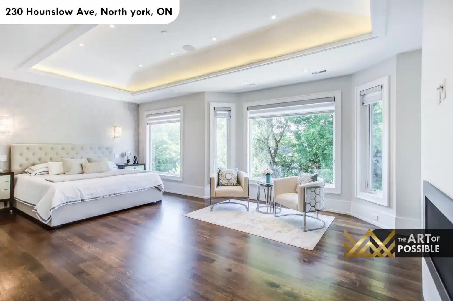 Primary suite alternate angle showing bay windows, fireplace and hardwood floors