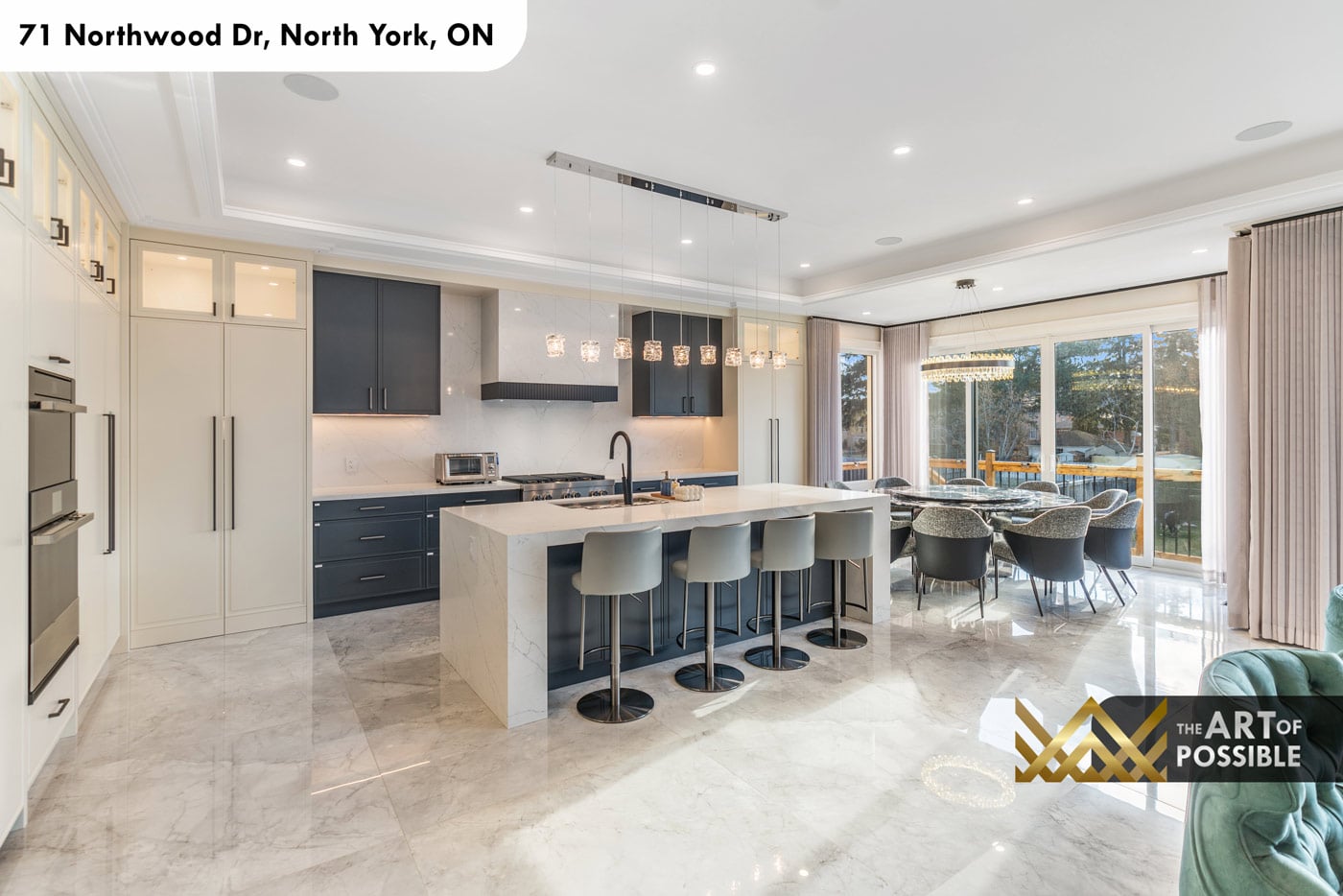 Kitchen and breakfast dining area showing waterfall island and sliding doors to rear deck