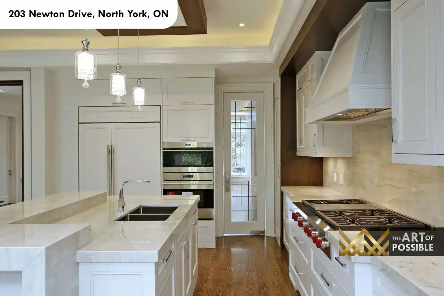 Kitchen and breakfast area with rectangular crystal chandelier and garden windows