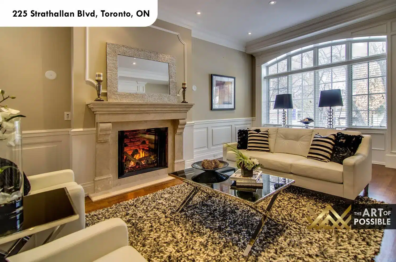 225 Strathallan Blvd Toronto - Living room with limestone fireplace and arched bay window