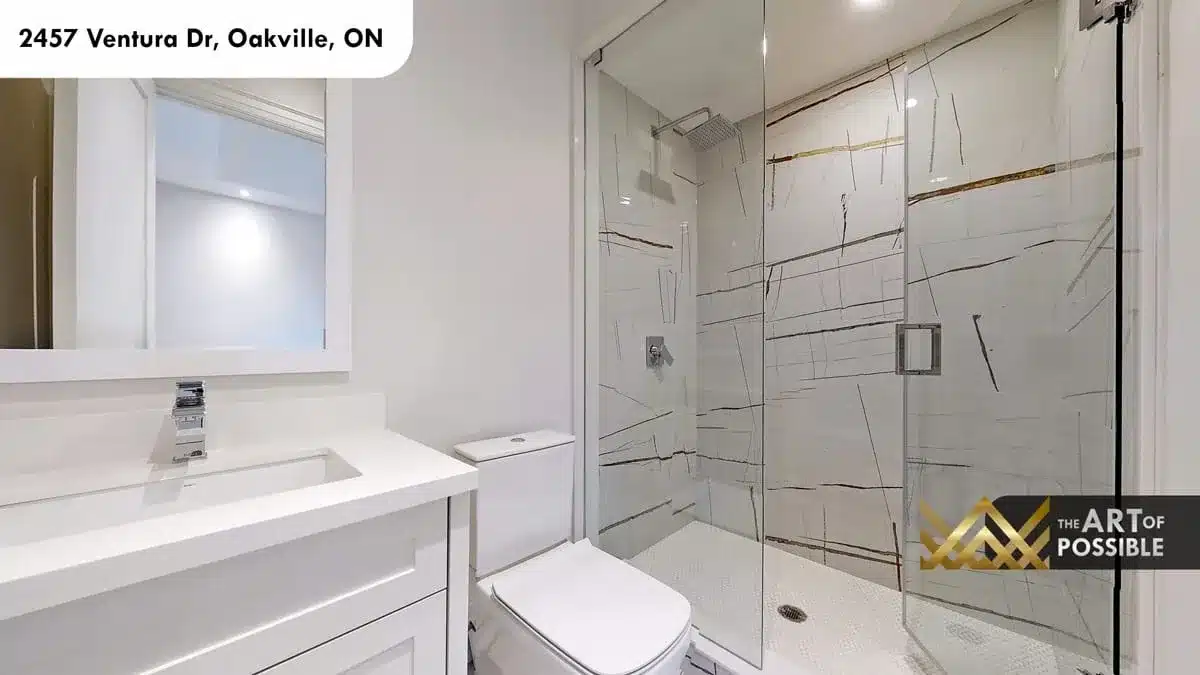 Upper floor bathroom with boldly veined white marble shower glass enclosure and chrome rain head