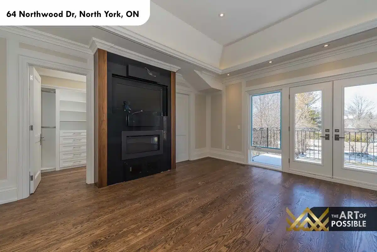 Primary bedroom fireplace feature wall with walnut surround and walk-in closet