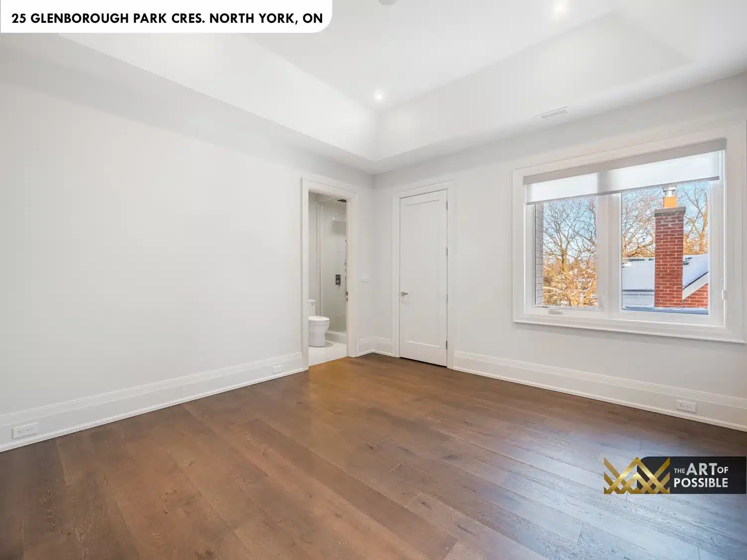 Primary bedroom with tray ceiling and white marble fireplace surround