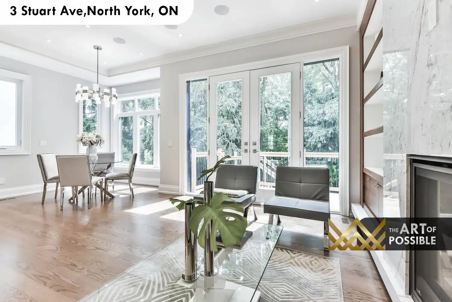 Family room with French doors opening to rear deck, marble fireplace surround and hardwood floors