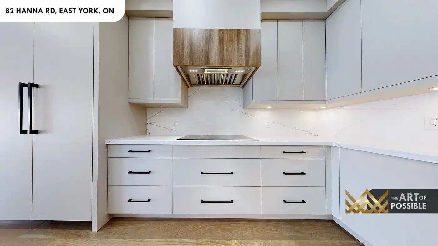 Walnut range hood and Calacatta marble backsplash in the kitchen at 82 Hanna Rd