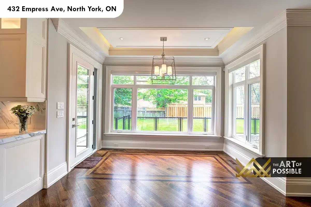 432 Empress Ave - breakfast area with tray ceiling, lantern pendant and wall of windows to backyard