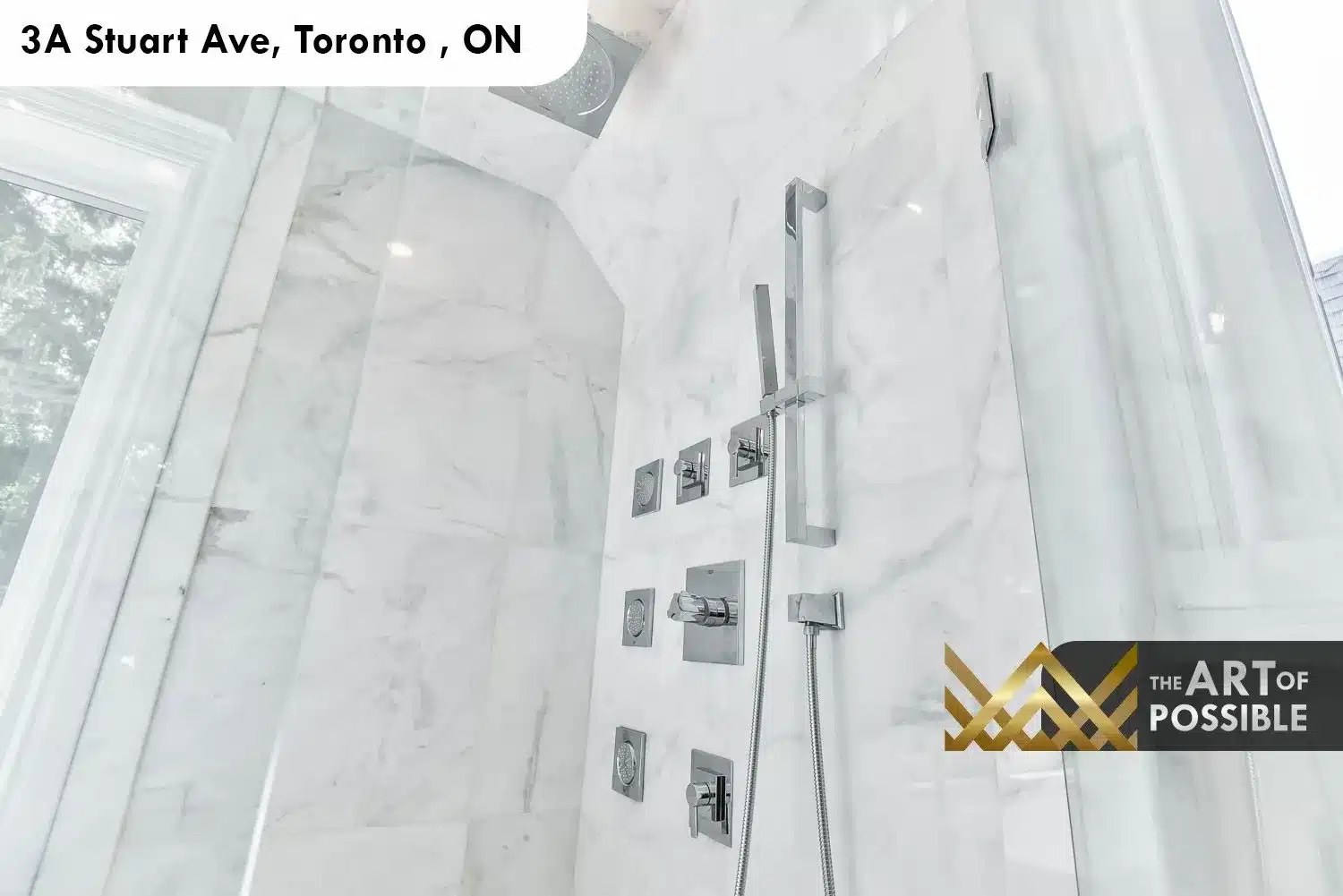 Close-up of marble shower interior with chrome body jets, rain head and handheld at 3A Stuart Ave ensuite