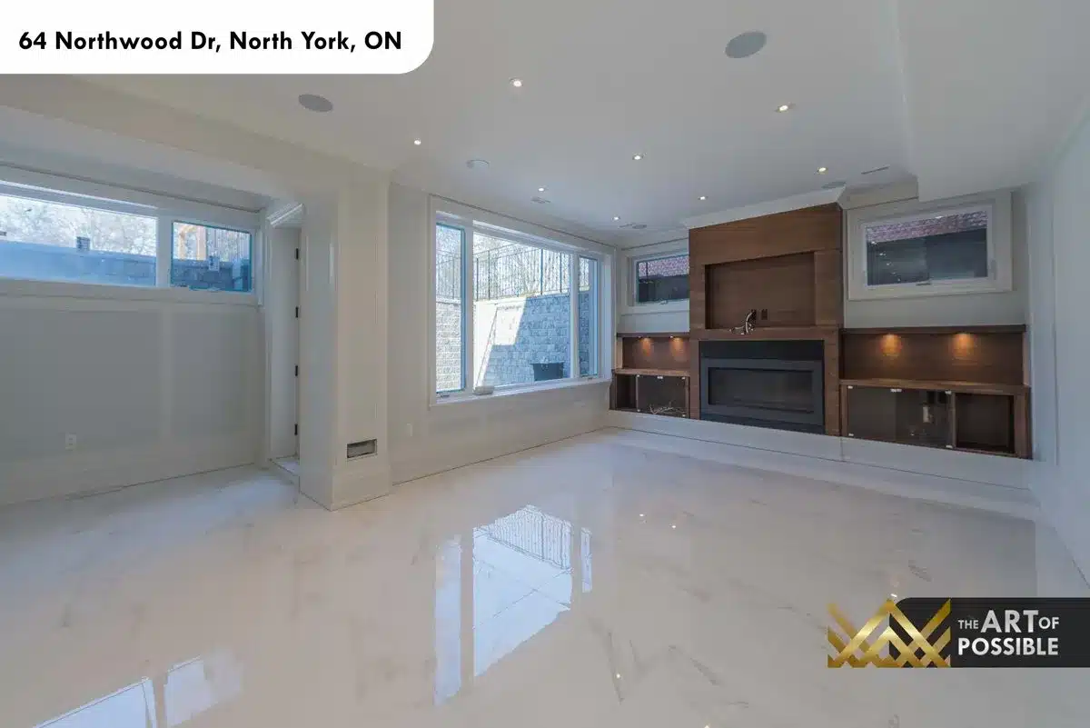 Lower level recreation room with walnut entertainment unit and linear fireplace