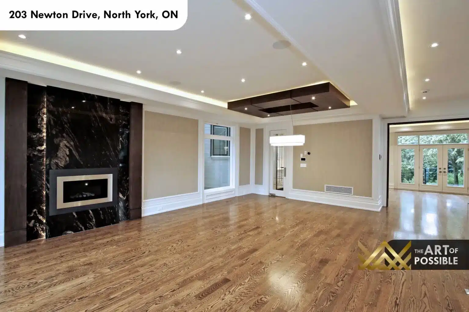 Formal room with dark marble fireplace, stainless surround and coffered ceiling