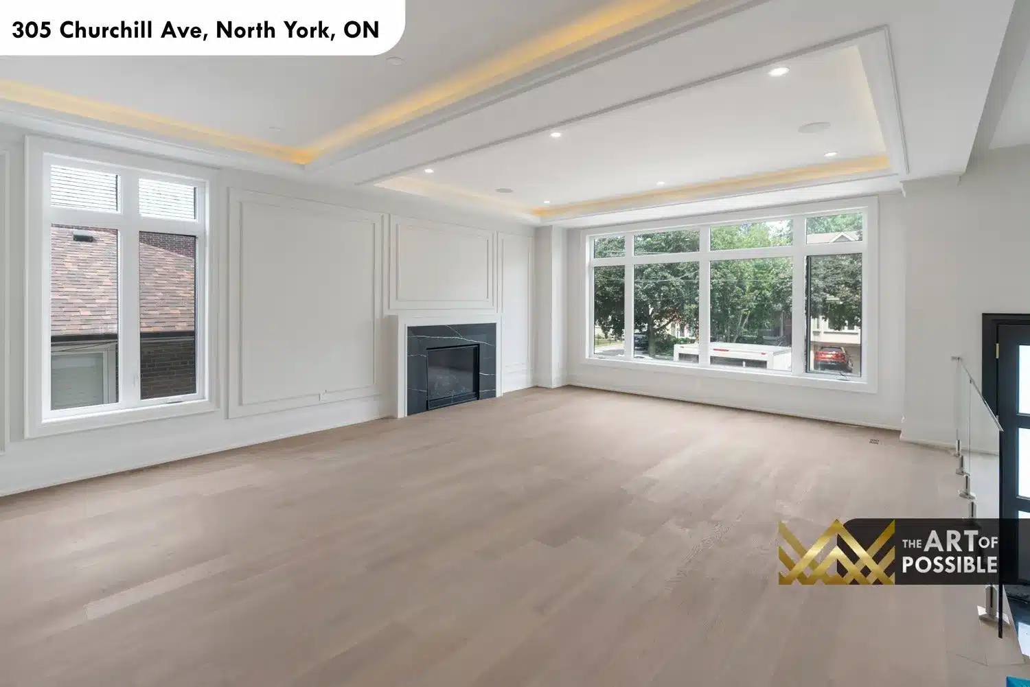Formal living room wide angle with panel moulding walls and large front-facing windows