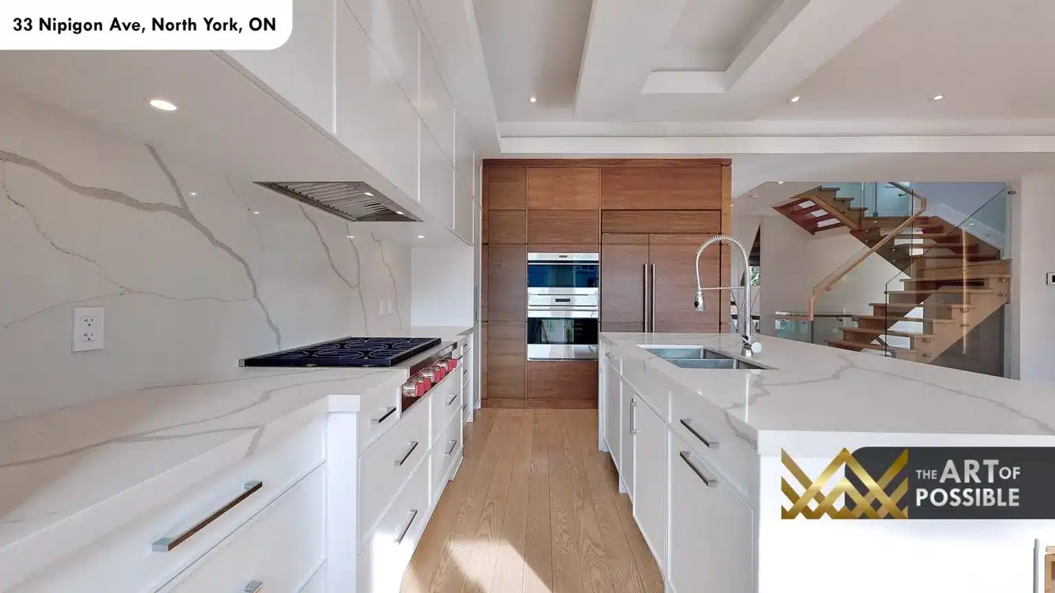 Kitchen showing full-height marble slab backsplash, gas range and walnut appliance wall