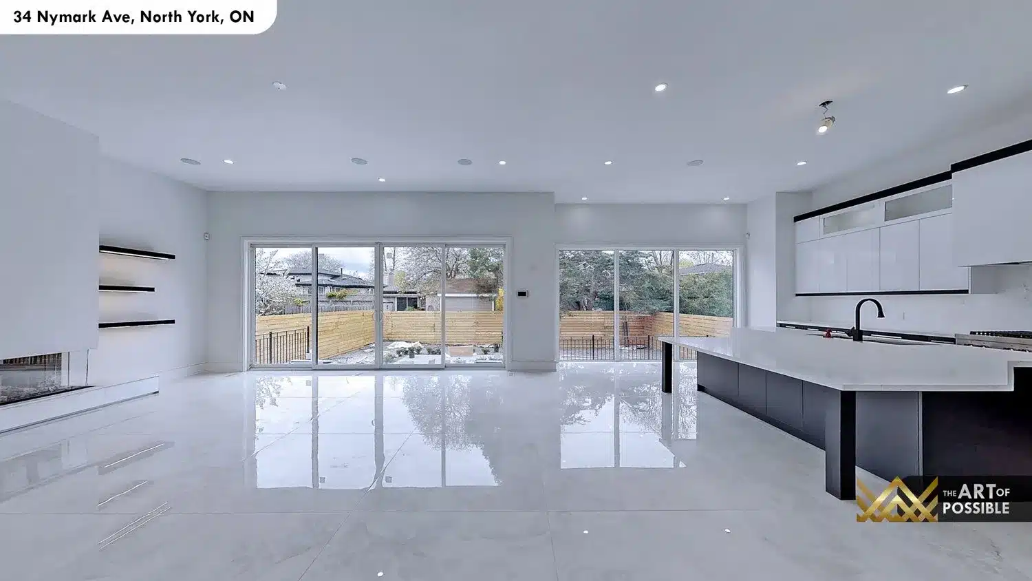 Main floor open plan wide angle showing dual multi-panel sliding glass doors across the full rear wall