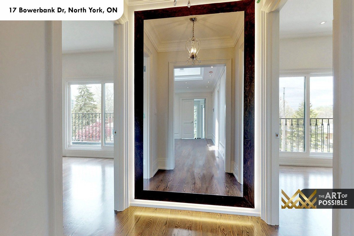 Upper hallway with large walnut-framed mirror and views to Mansard-level balconies
