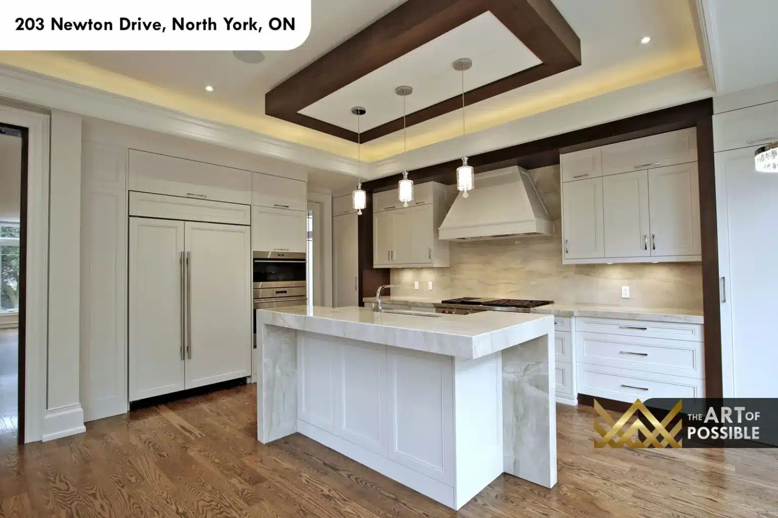 Waterfall quartzite island under a coffered ceiling with dark wood inlay