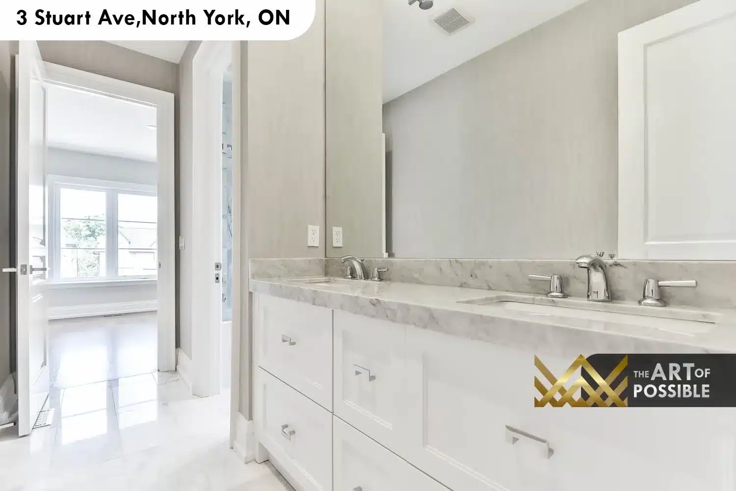 Secondary bathroom with white shaker double vanity, marble countertop, chrome faucets and full-width mirror