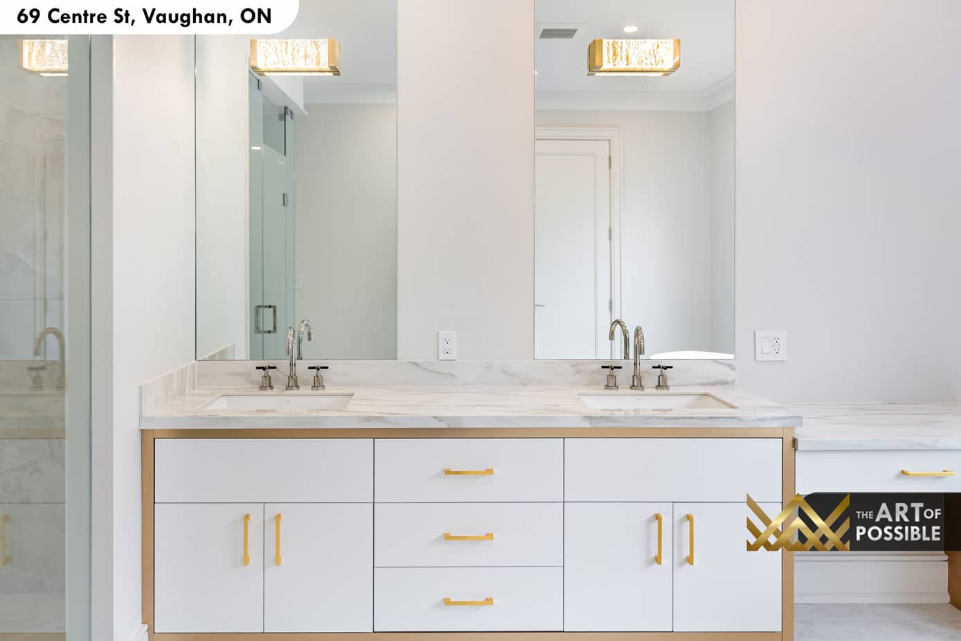 Primary ensuite double vanity with gold brass hardware and crystal wall sconces