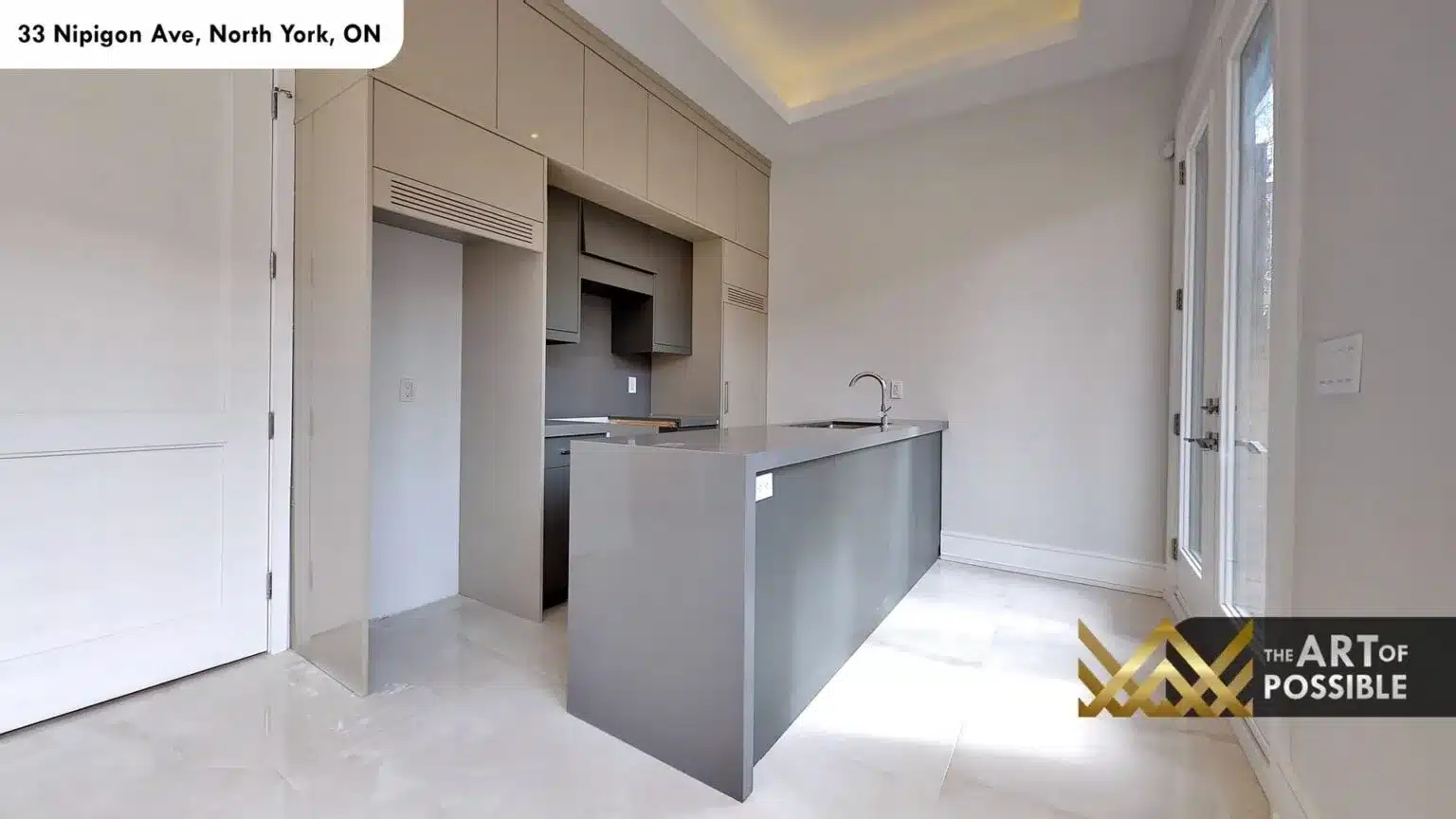 Lower level second kitchen with grey flat-panel cabinetry and grey island