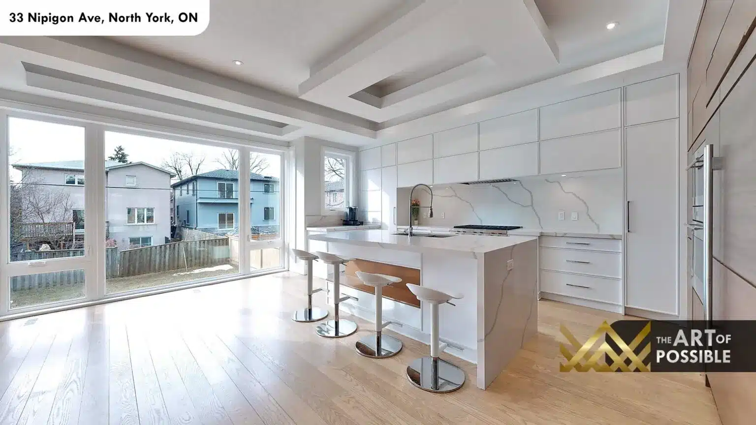 Kitchen with full-height quartz backsplash and large sliding glass doors to backyard