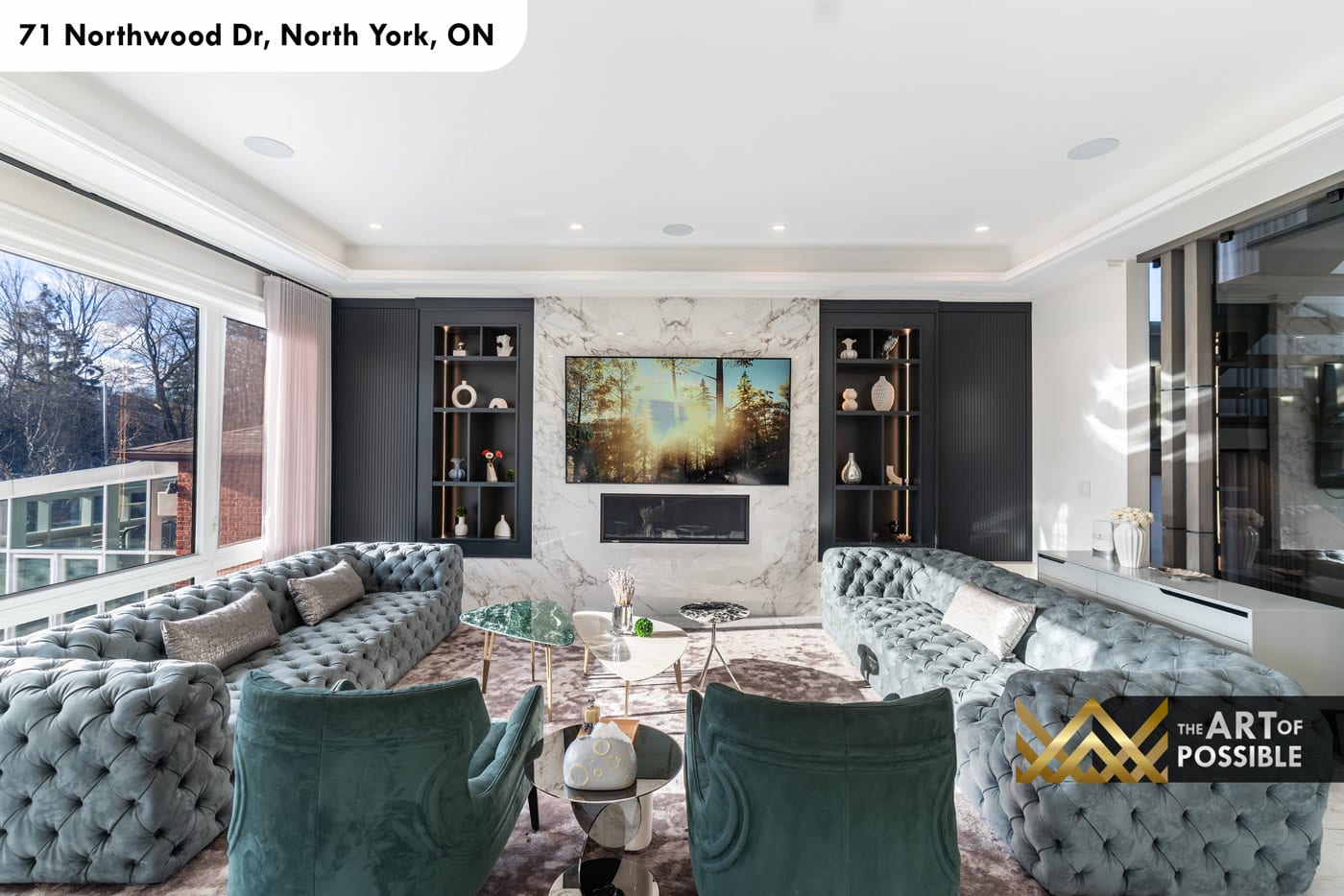Family room with grey tufted Chesterfield sofas and rear garden view windows