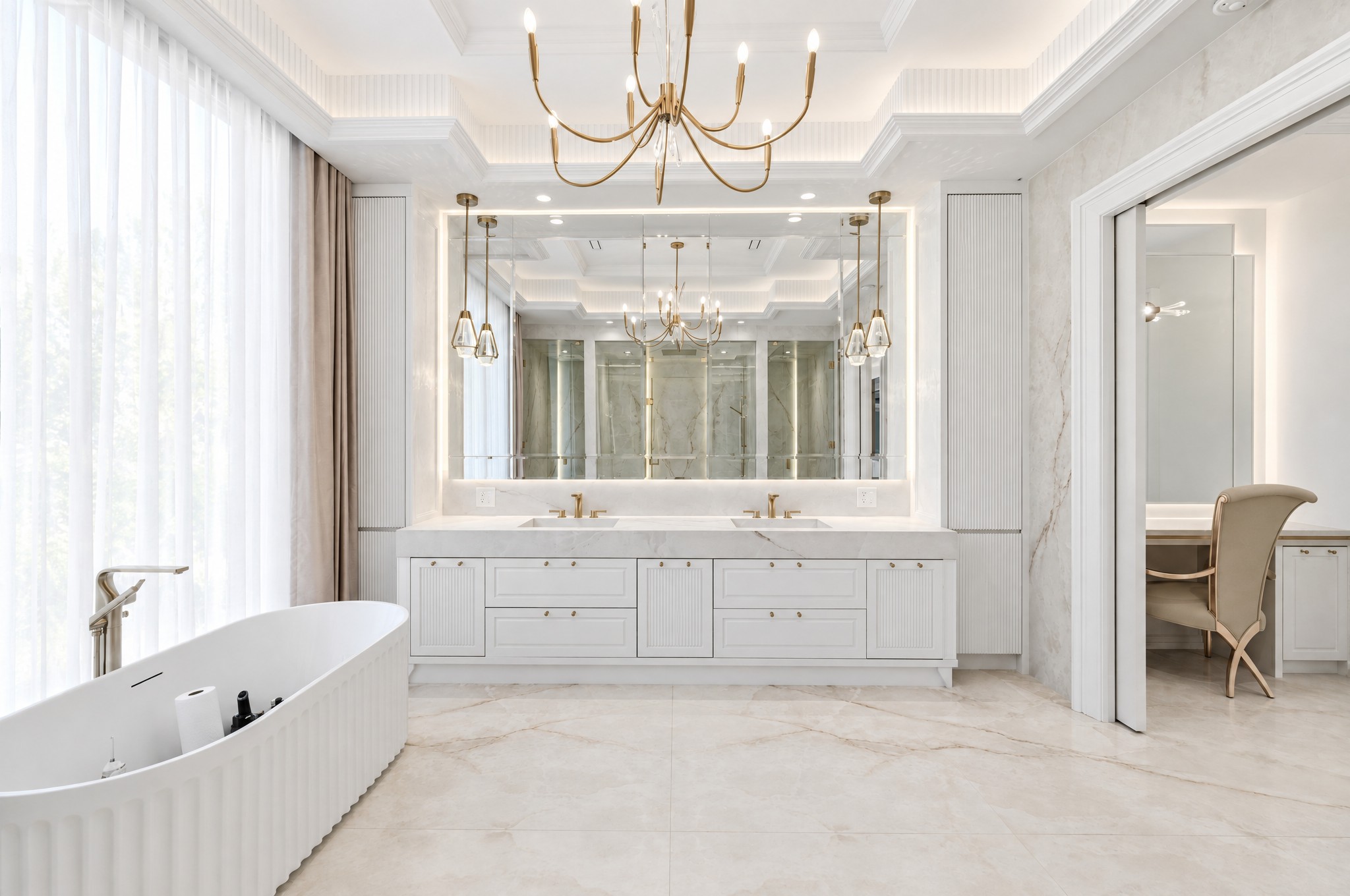 Primary ensuite with fluted freestanding tub, double vanity and backlit mirror