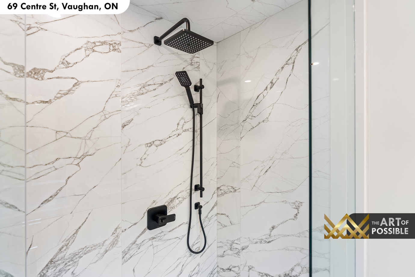 Secondary ensuite shower with matte black rain head and Calacatta marble tile