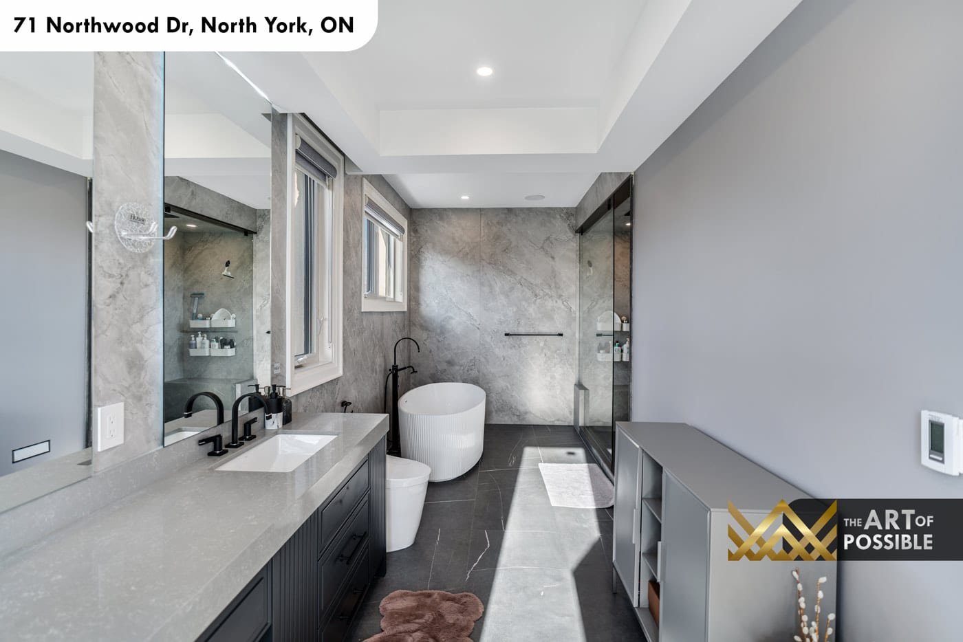 Primary ensuite overview showing double vanity, soaker tub and walk-in shower in grey stone