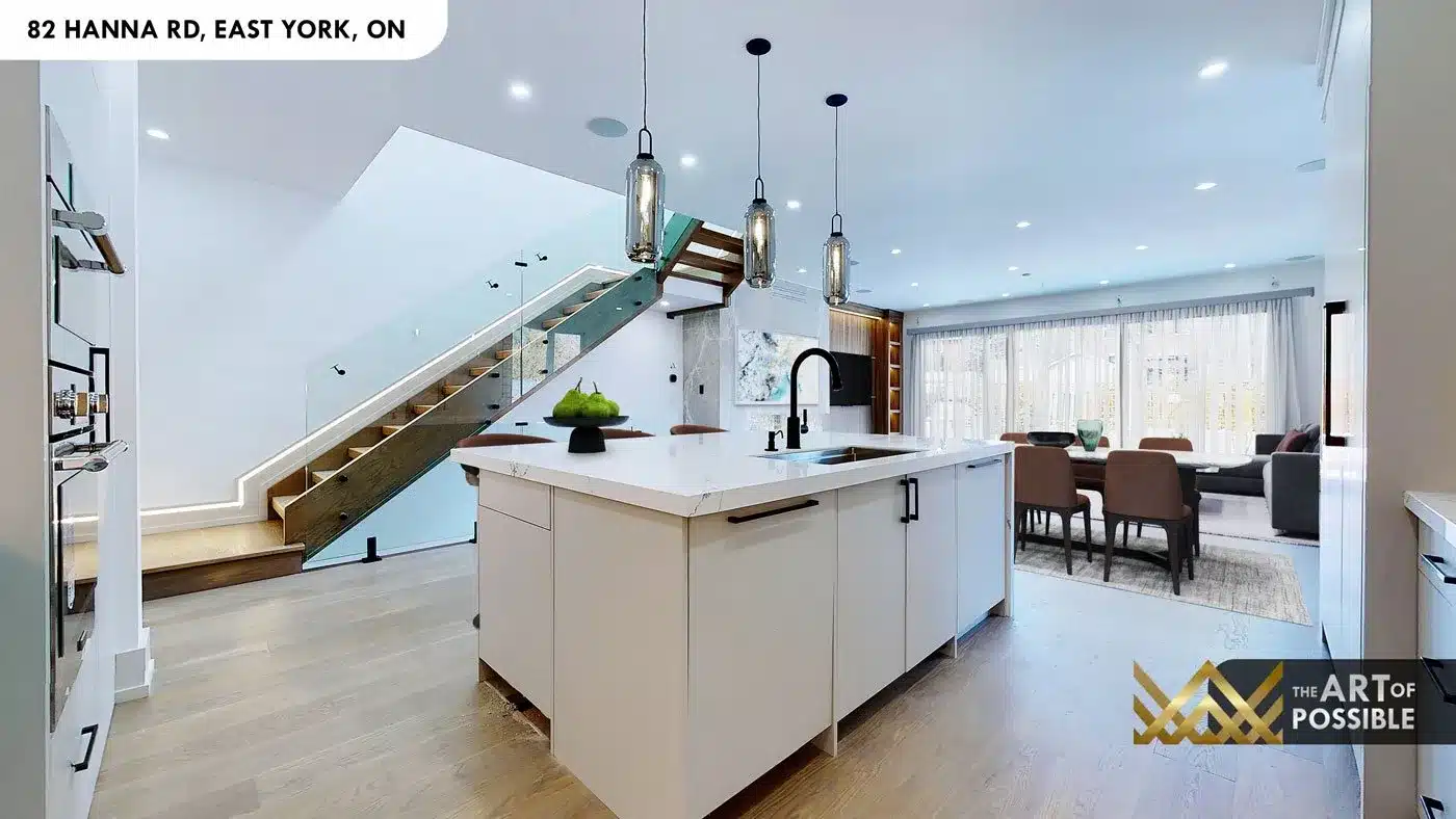 Kitchen and staircase view at 82 Hanna Rd showing glass railing and pendant lights