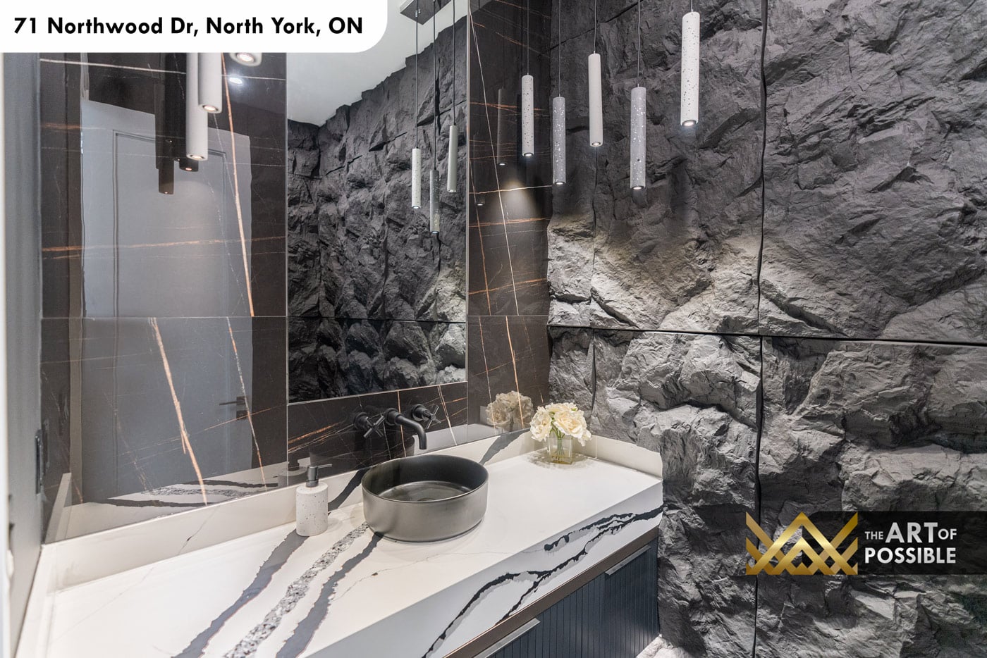 Powder room vanity detail with white quartz countertop, matte black vessel sink and cylinder pendants