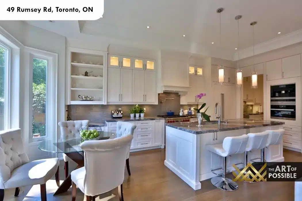 49 Rumsey Rd kitchen white shaker cabinetry marble island glass pendant lights bay window