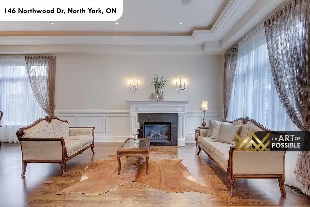 Living room with marble gas fireplace, crystal sconces and cowhide rug