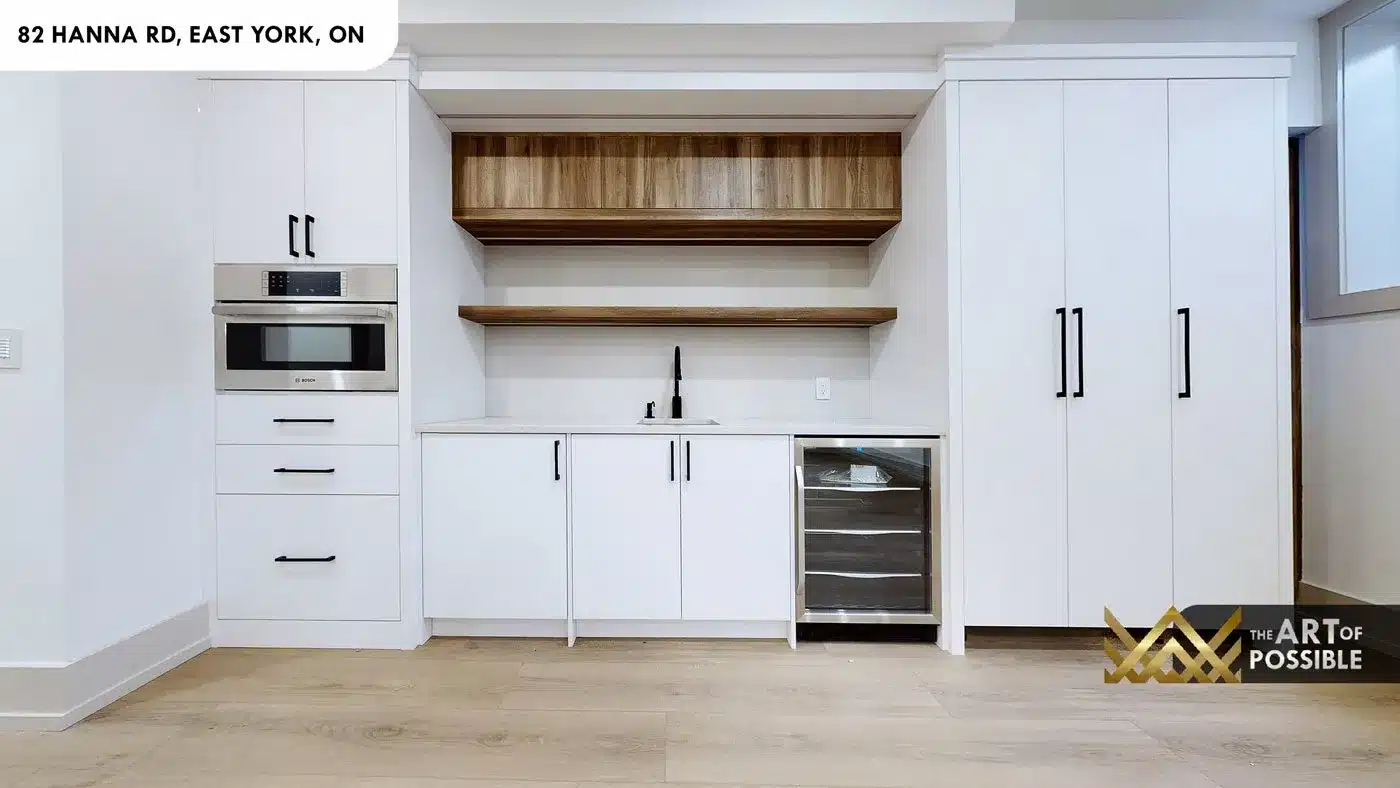 Basement wet bar with Bosch oven, beverage fridge and walnut shelves at 82 Hanna Rd