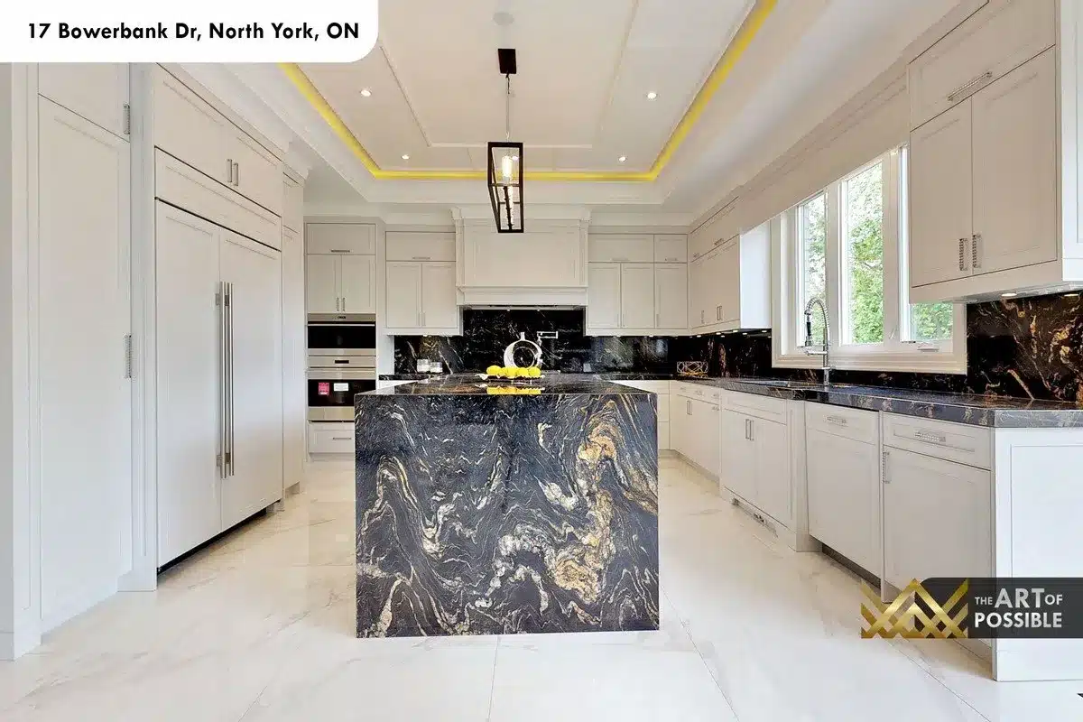 Kitchen at 17 Bowerbank Drive with black-and-gold marble waterfall island and white shaker cabinetry