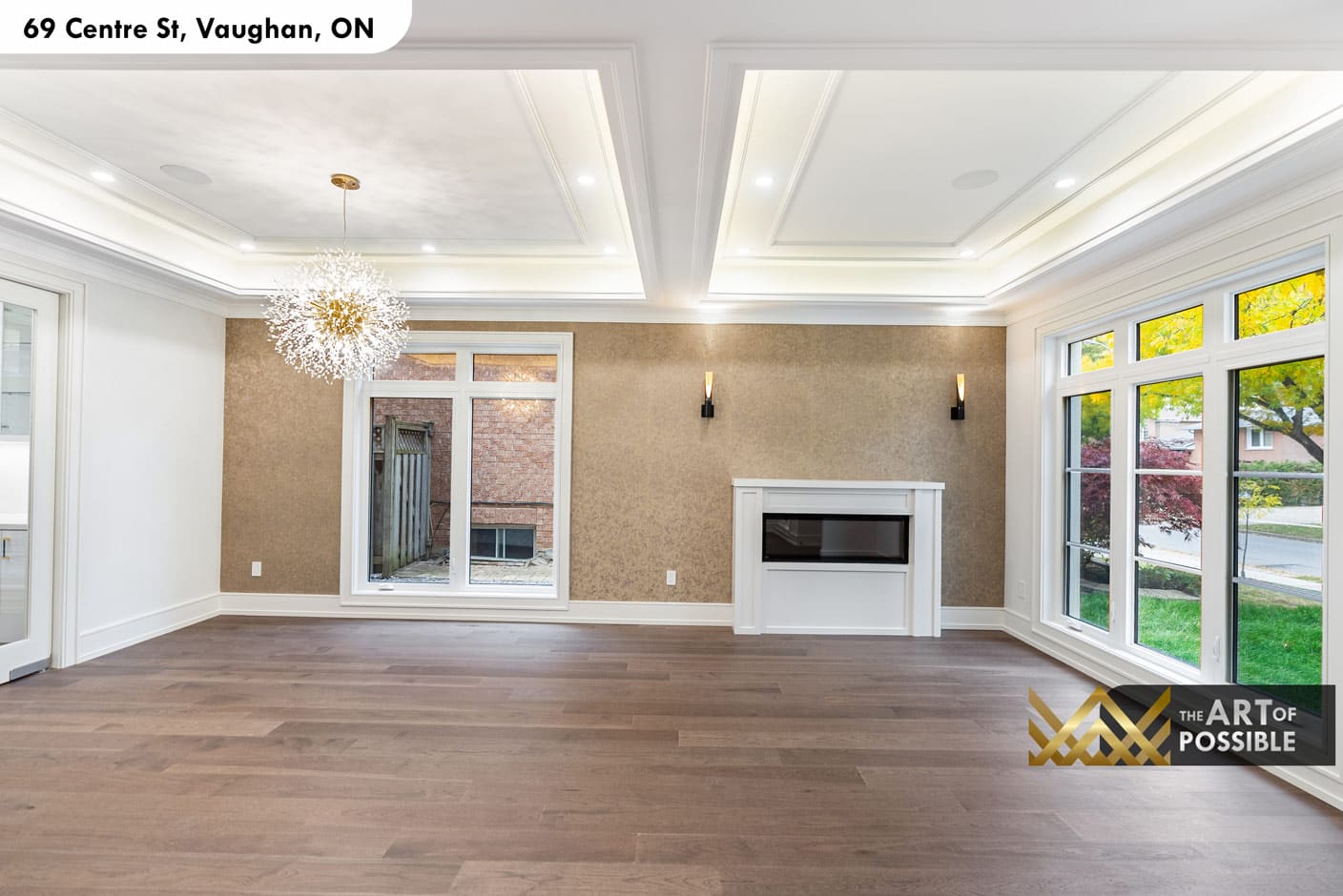 Open-concept living and dining with gold sputnik chandelier and metallic wallpaper feature wall