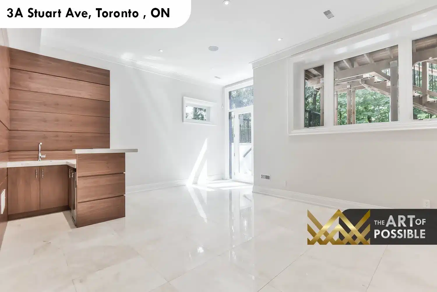 Walkout lower level at 3A Stuart Ave showing glass door to rear patio and polished tile floors