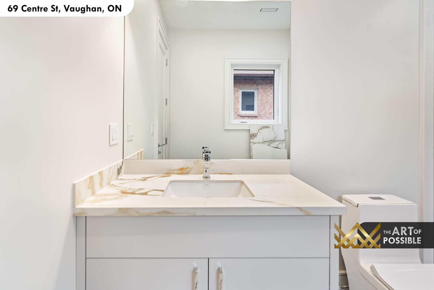 Secondary ensuite with grey flat-front vanity and gold-veined marble countertop