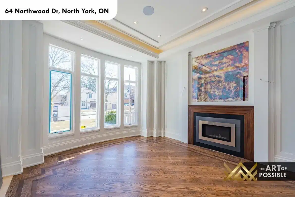 Living room bay windows and walnut fireplace surround