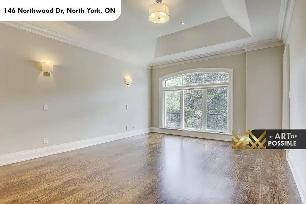 Secondary bedroom with tray ceiling and arched picture window