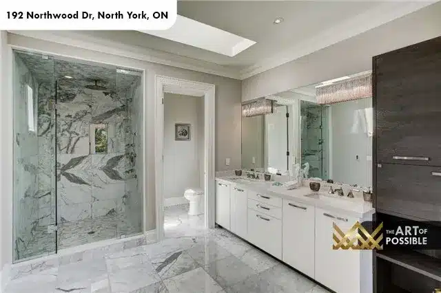 Primary ensuite with book-matched marble shower and skylight, 192 Northwood Dr