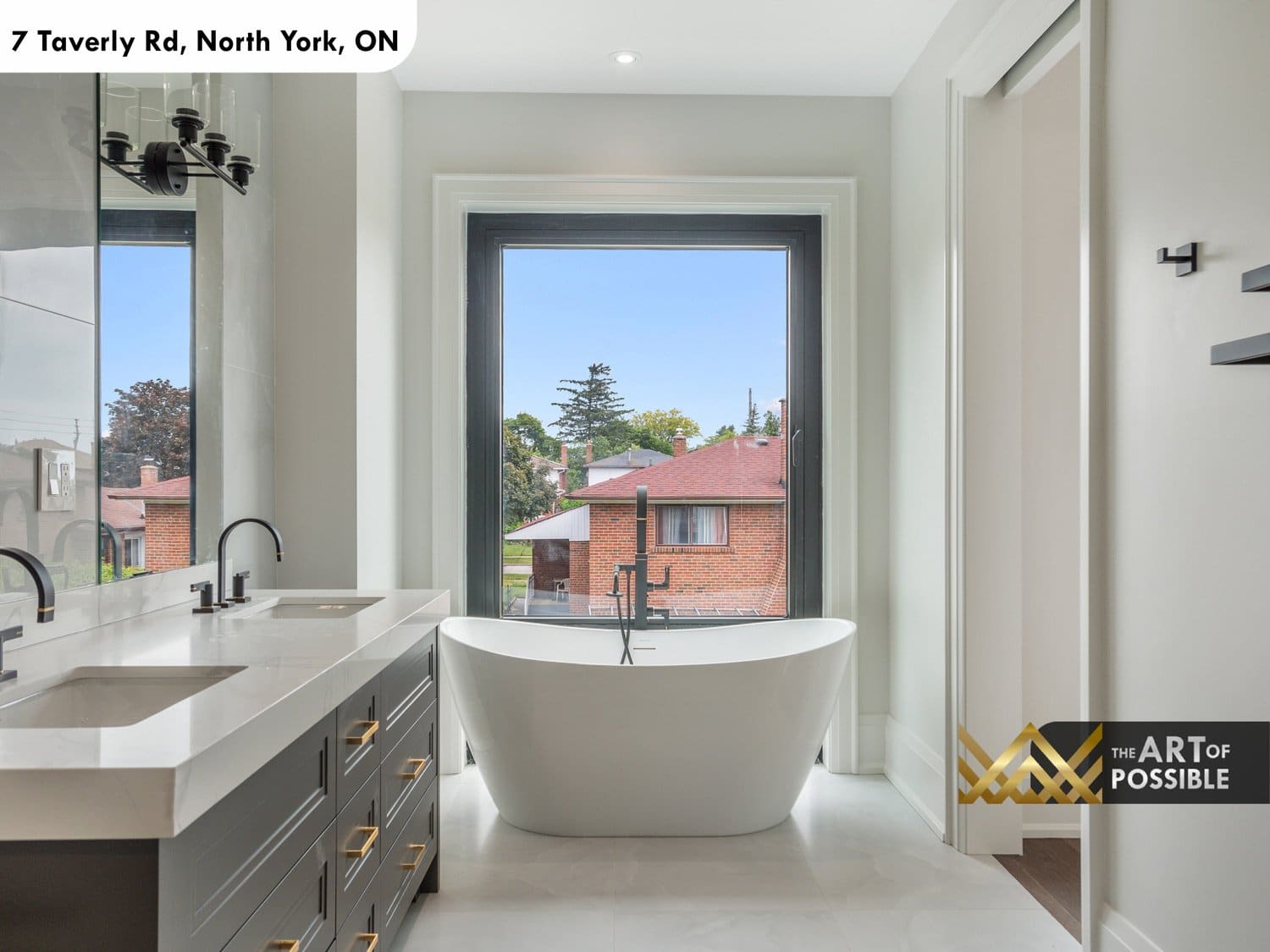 Primary ensuite with freestanding soaker tub under window