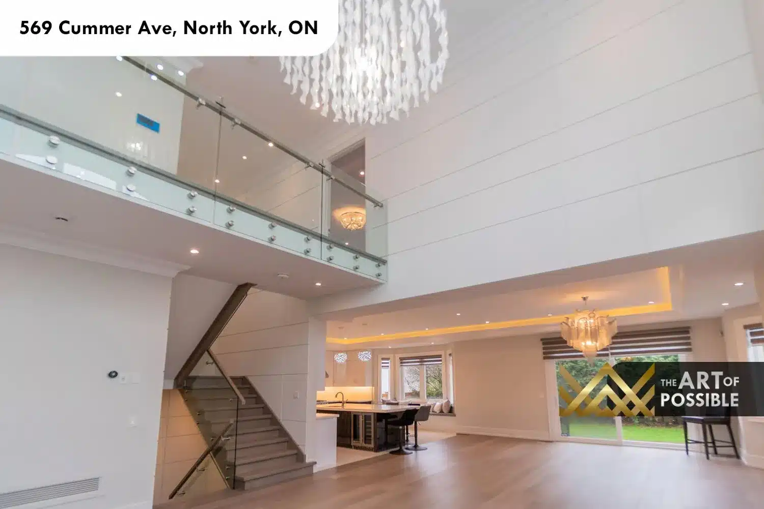 569 Cummer Ave open concept main floor from foyer glass railing staircase kitchen beyond